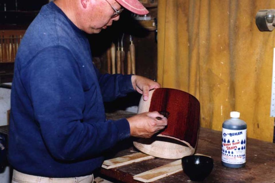 Ray Arifuku stains the wood of a small taiko